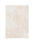 Floral notebook with text on a beige background