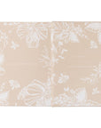 Floral patterned product packaging on a beige background