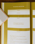 Open book with yellow and white pages on a wooden surface