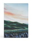 Notebook with a scenic design of mountains and water, featuring text on a white background.