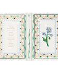Open book with floral design and text on a white background