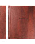 Two brown leather journals on a white background