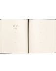 Open notebook with July 01 on a white background