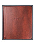Brown leather-bound book with 'ONE THING I ASK' embossed on a white background