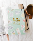 Bible study stickers book with a cup of coffee on a white surface