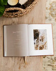 Open book with a photo of a castle on a wooden surface