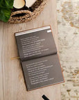 Open book with text on a wooden surface