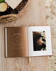 Open book with a photo on a wooden surface