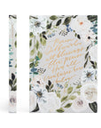 Floral notebook with inspirational quote on a white background