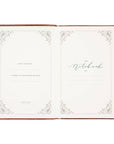 Open notebook with decorative cover and white pages on a white background