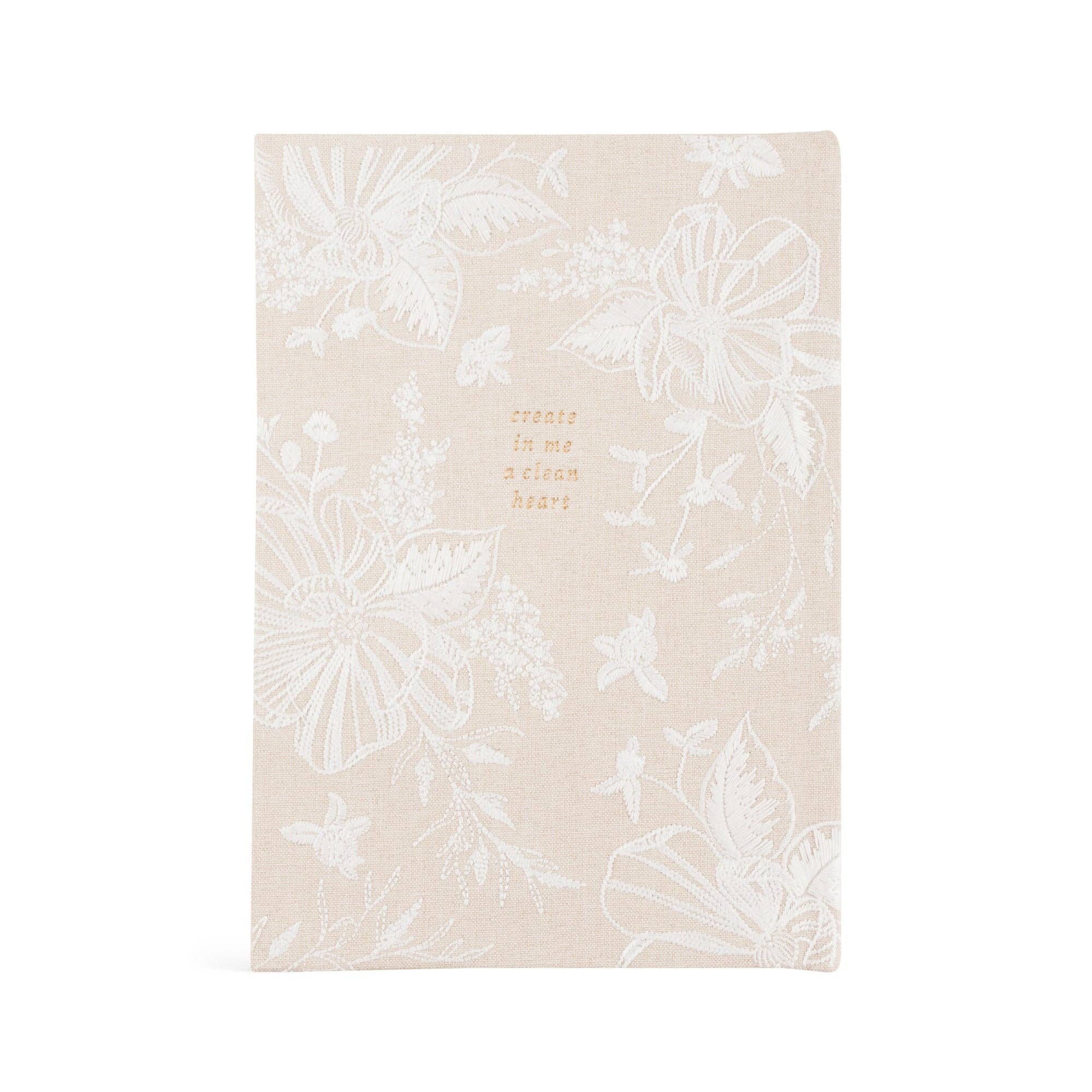 Floral notebook with text on a beige background
