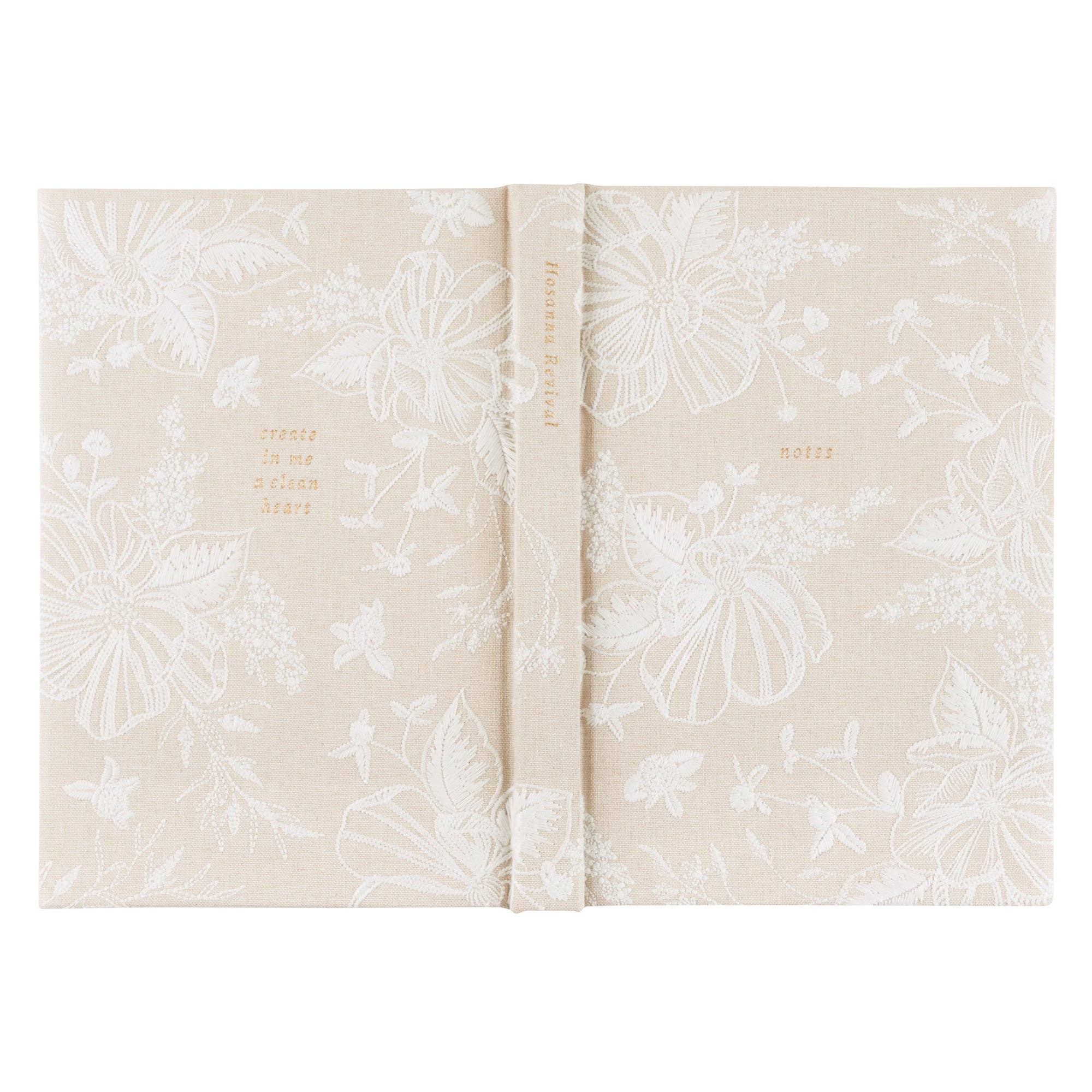 Floral-patterned notebook with text on a white background