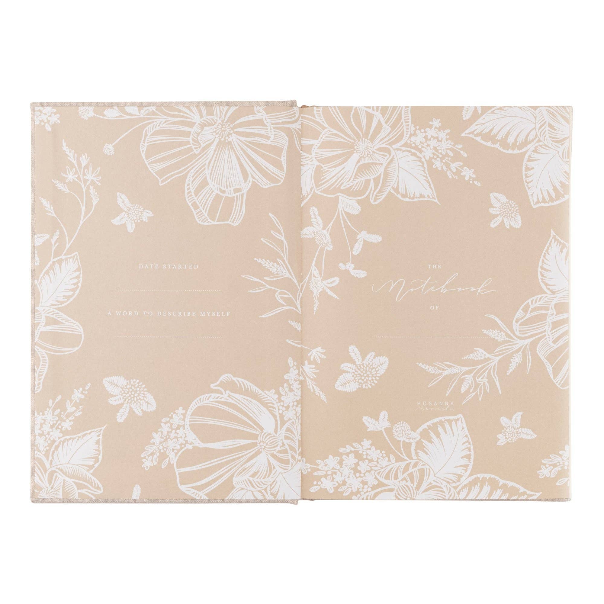 Two beige notebooks with white floral patterns on a white background