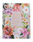 Floral notebook with inspirational quote on a white background