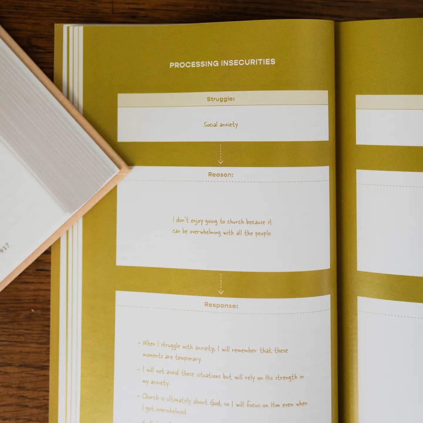 Open book with yellow and white pages on a wooden surface