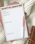 Notepad with a pen on a textured surface