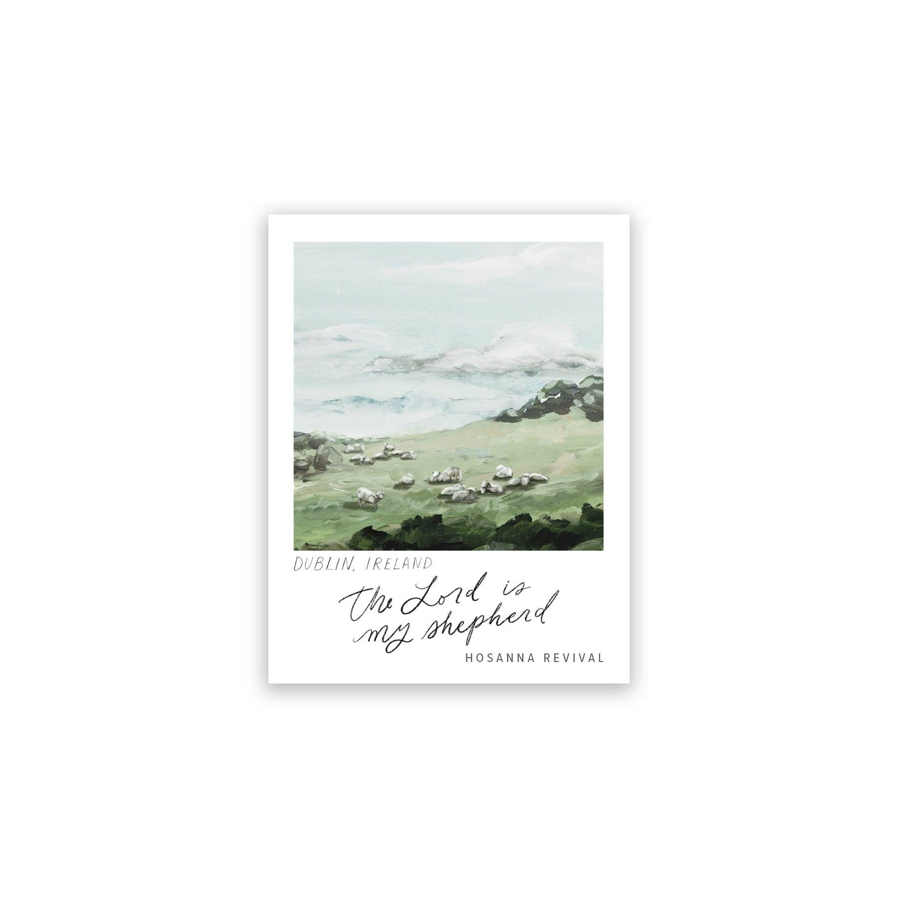 Framed artwork of a pastoral scene with sheep in a field, featuring text at the bottom.