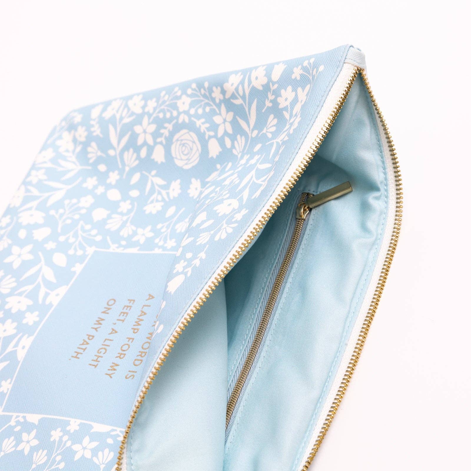 Light blue pouch with floral pattern and gold zipper on a white background