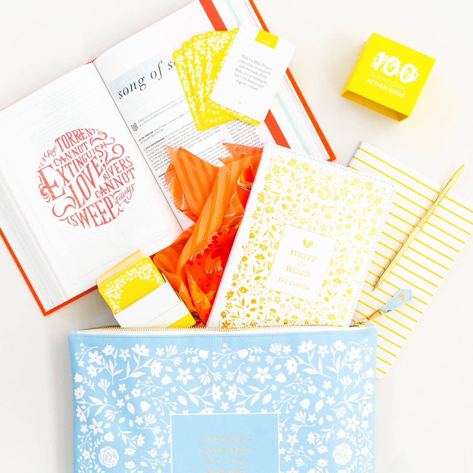 Collection of stationery items including notebooks, a book, and a box on a white background
