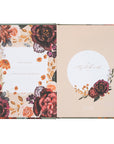 Floral notebook with decorative cover and beige interior on a white background