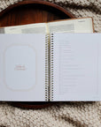 Open spiral-bound notebook on a textured surface