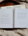 Open spiral-bound book on a textured surface