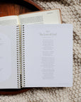Open book on a textured surface with visible text