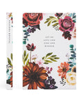Floral notebook with motivational quote on a white background