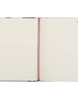 Open notebook with a pink ribbon on a white background