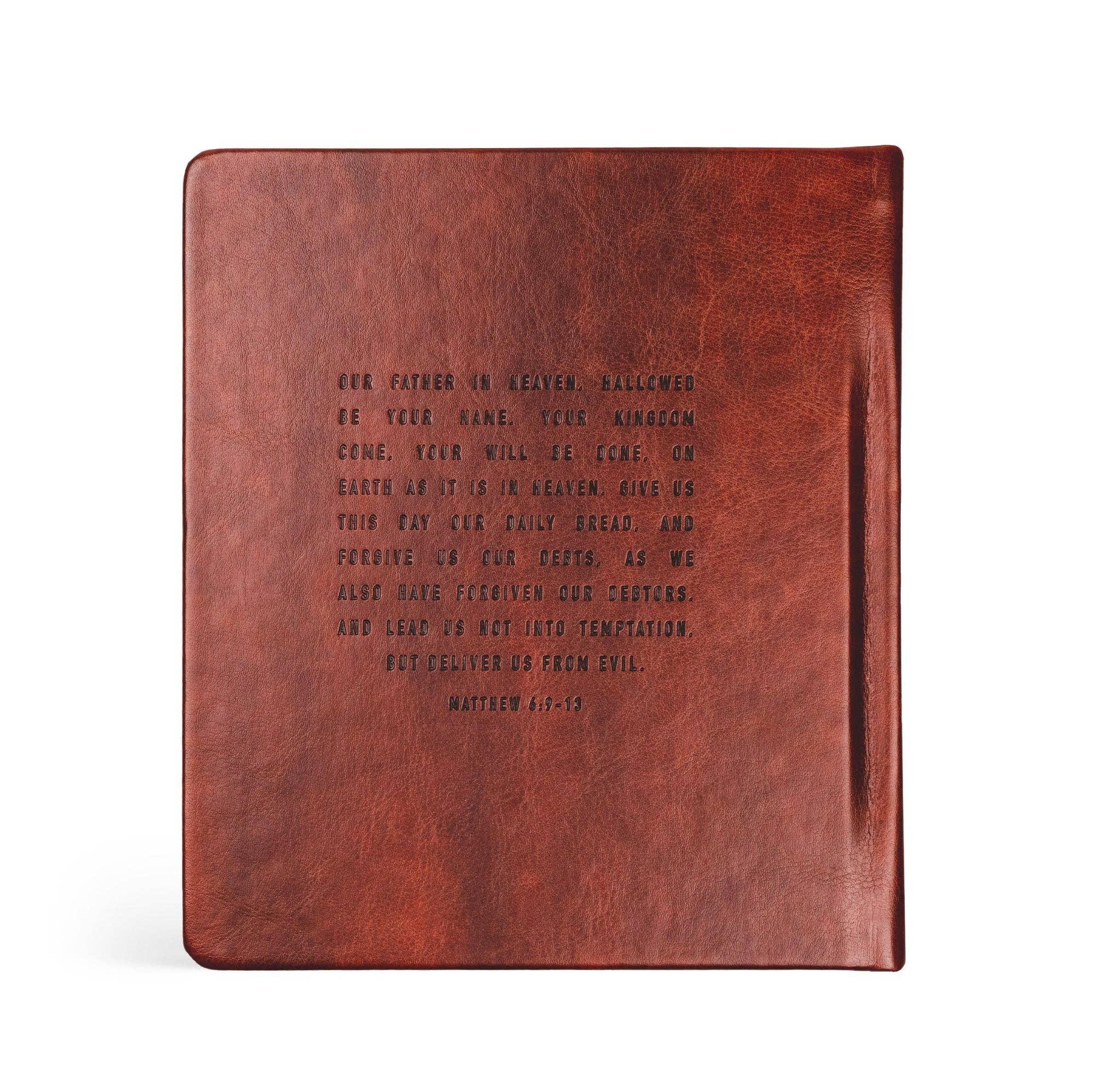 Brown leather notebook with engraved text on a white background