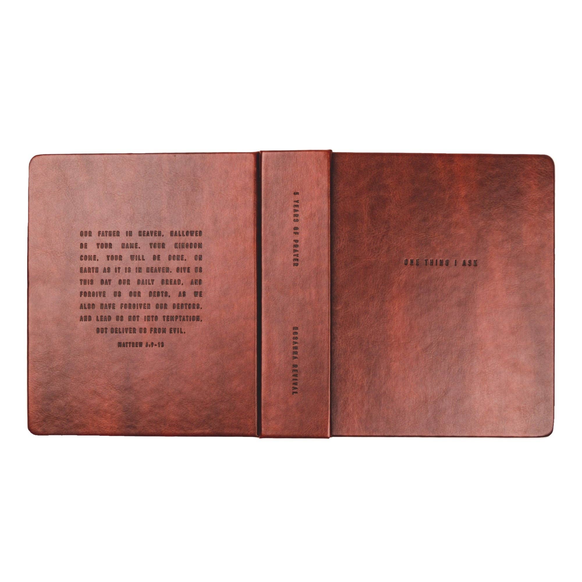 Brown leather notebook with text on a white background