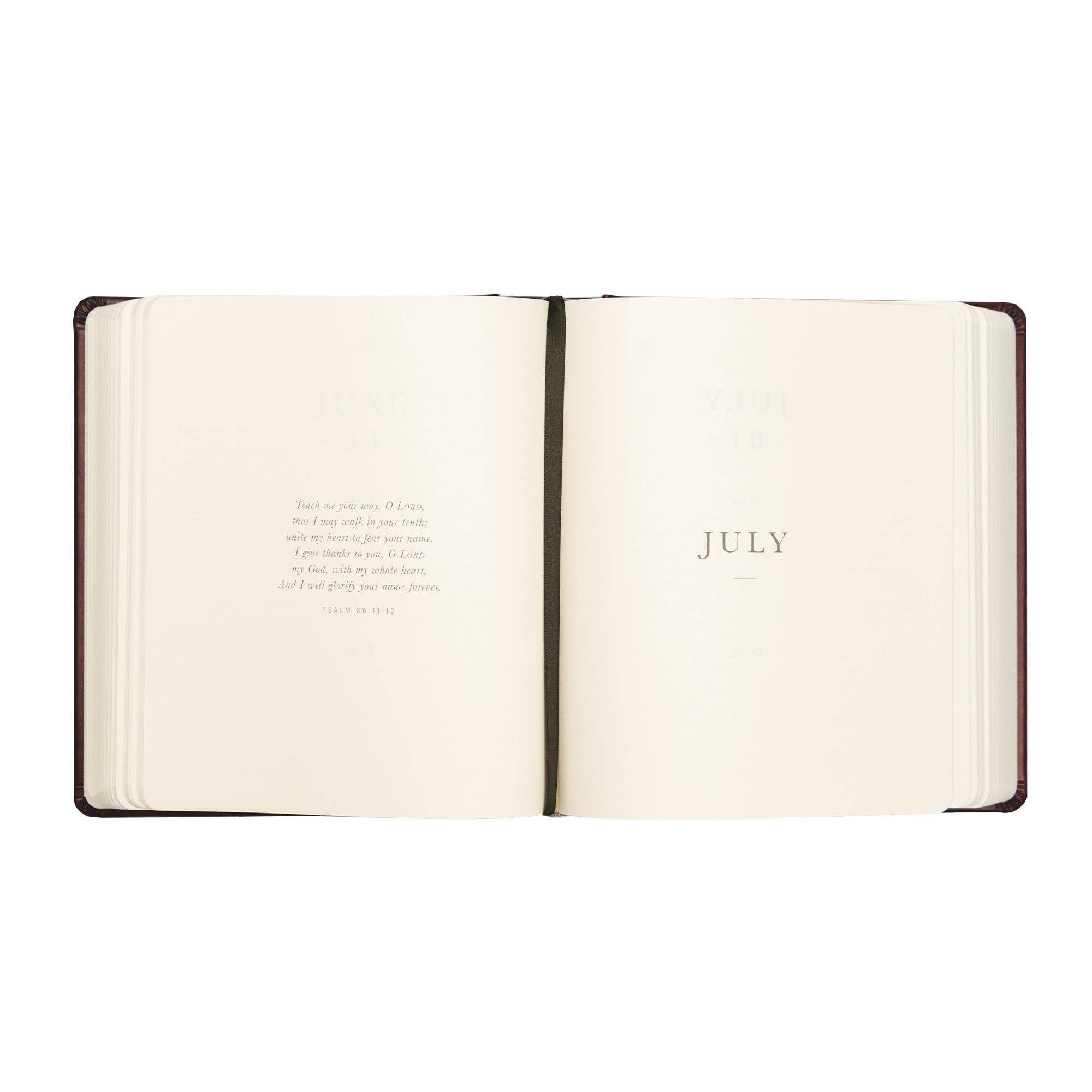 Open notebook showing the month of July on a white background