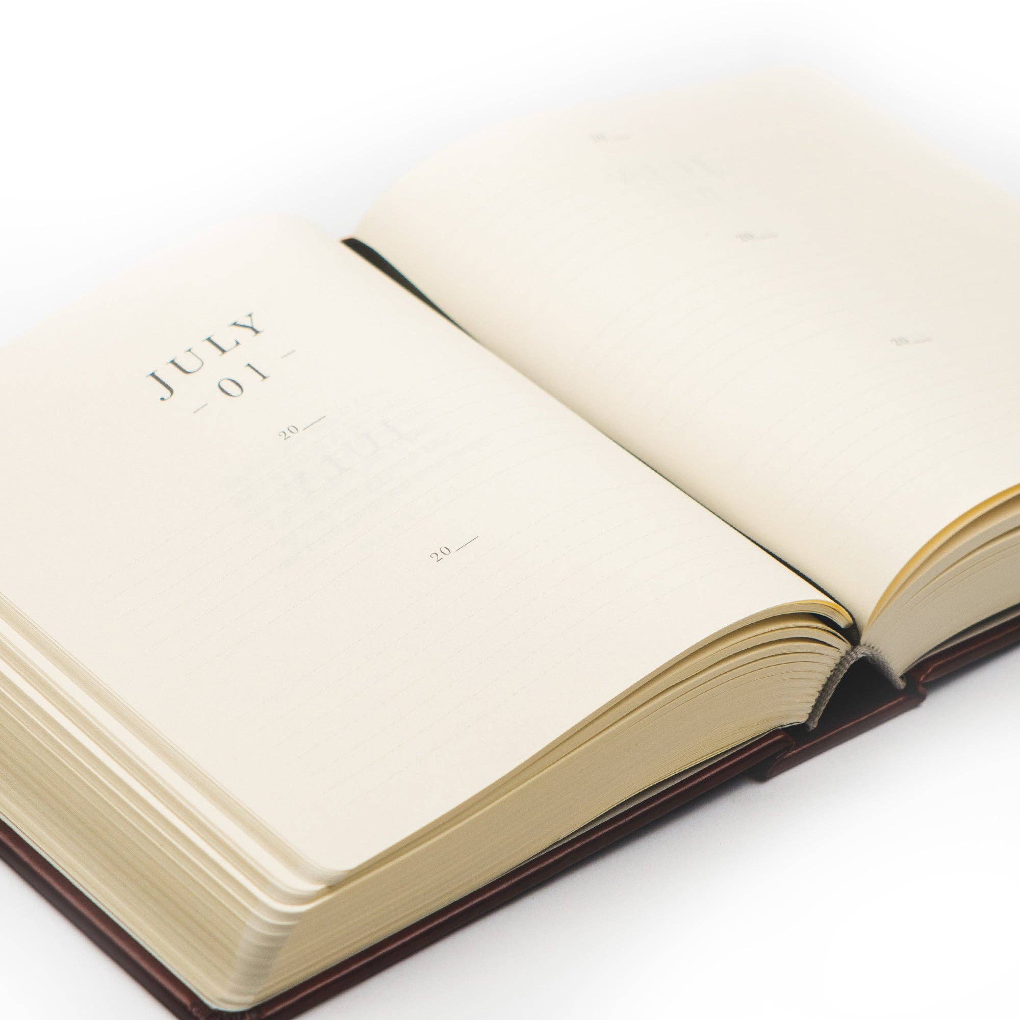 Open book with &#39;July 01&#39; on a white background