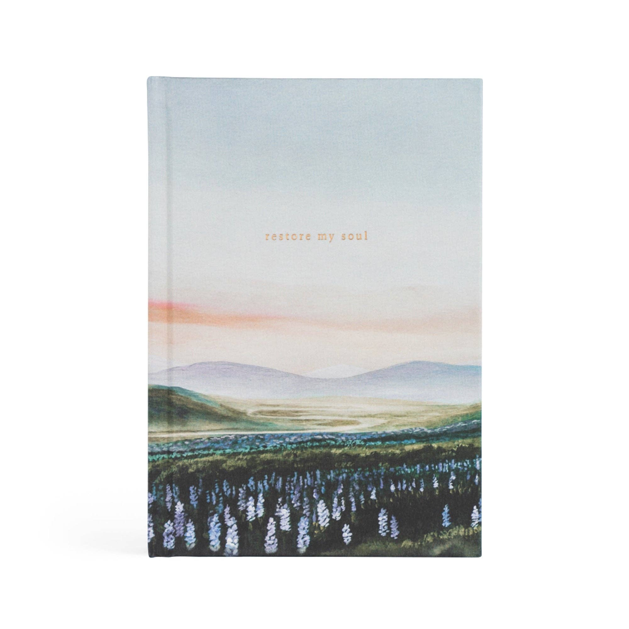 Journal with a scenic cover design and 'restore my soul' text on a white background