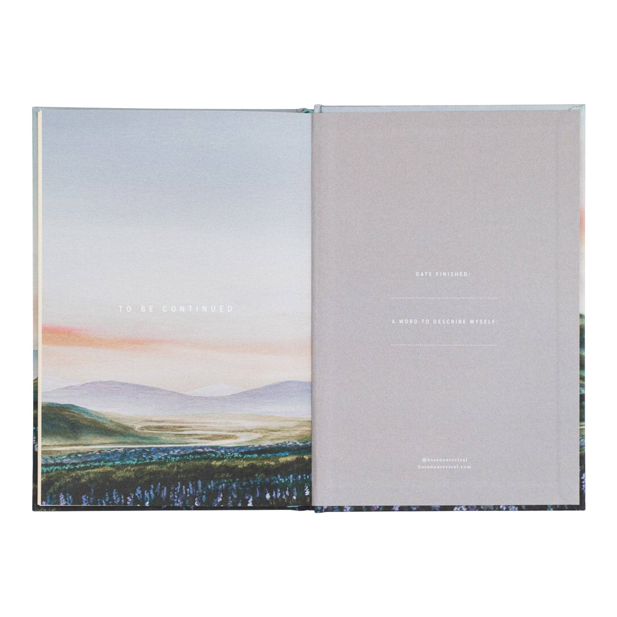 Open book with landscape illustration on one page and gray textured cover on the other