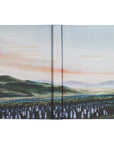 Open book with a landscape illustration on each page.