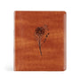 Brown leather-bound book with floral embossing on a white background