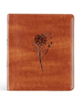 Brown leather-bound book with floral embossing on a white background