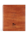 Brown leather-bound book with engraved text and logo on a white background