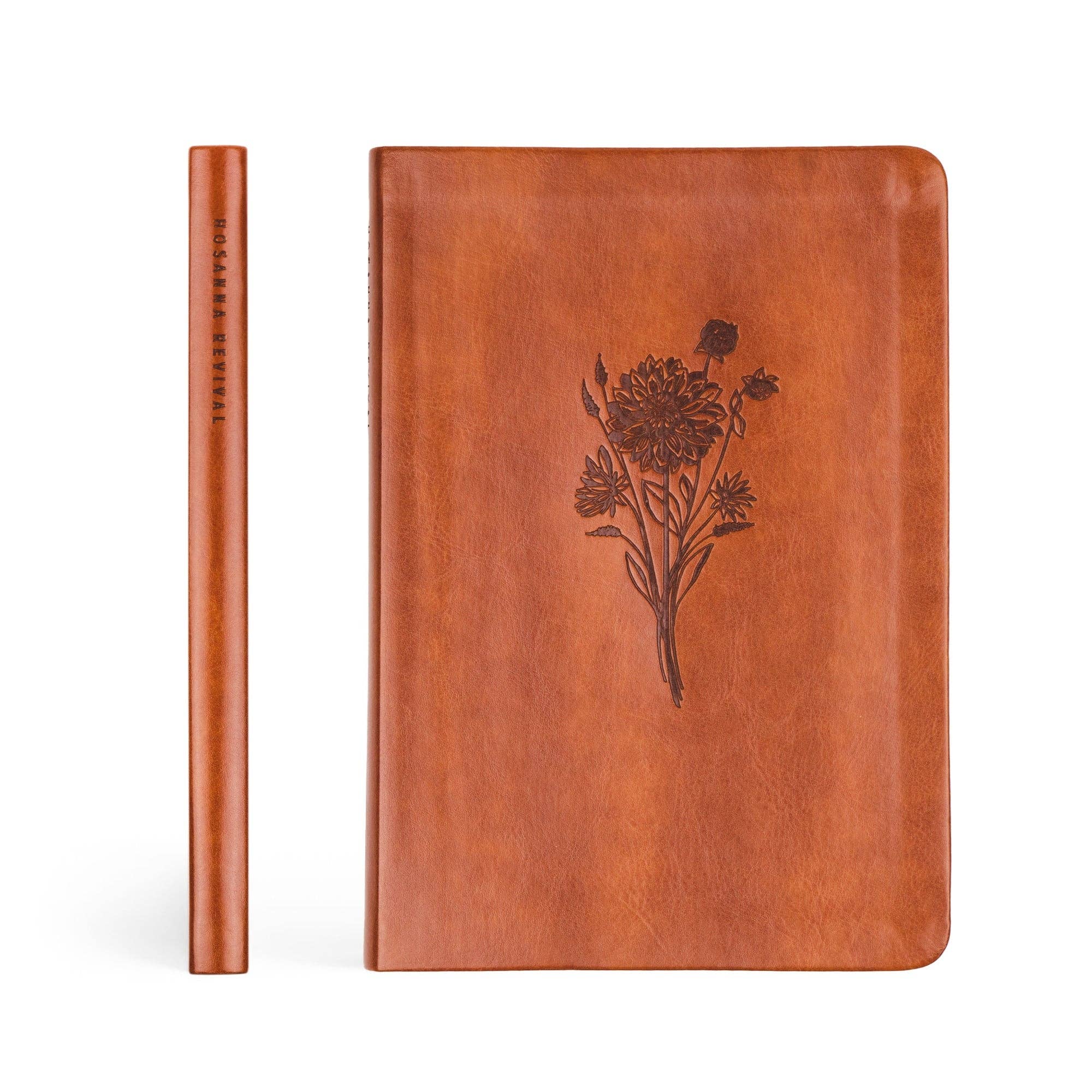 Brown leather notebook with floral design on a white background