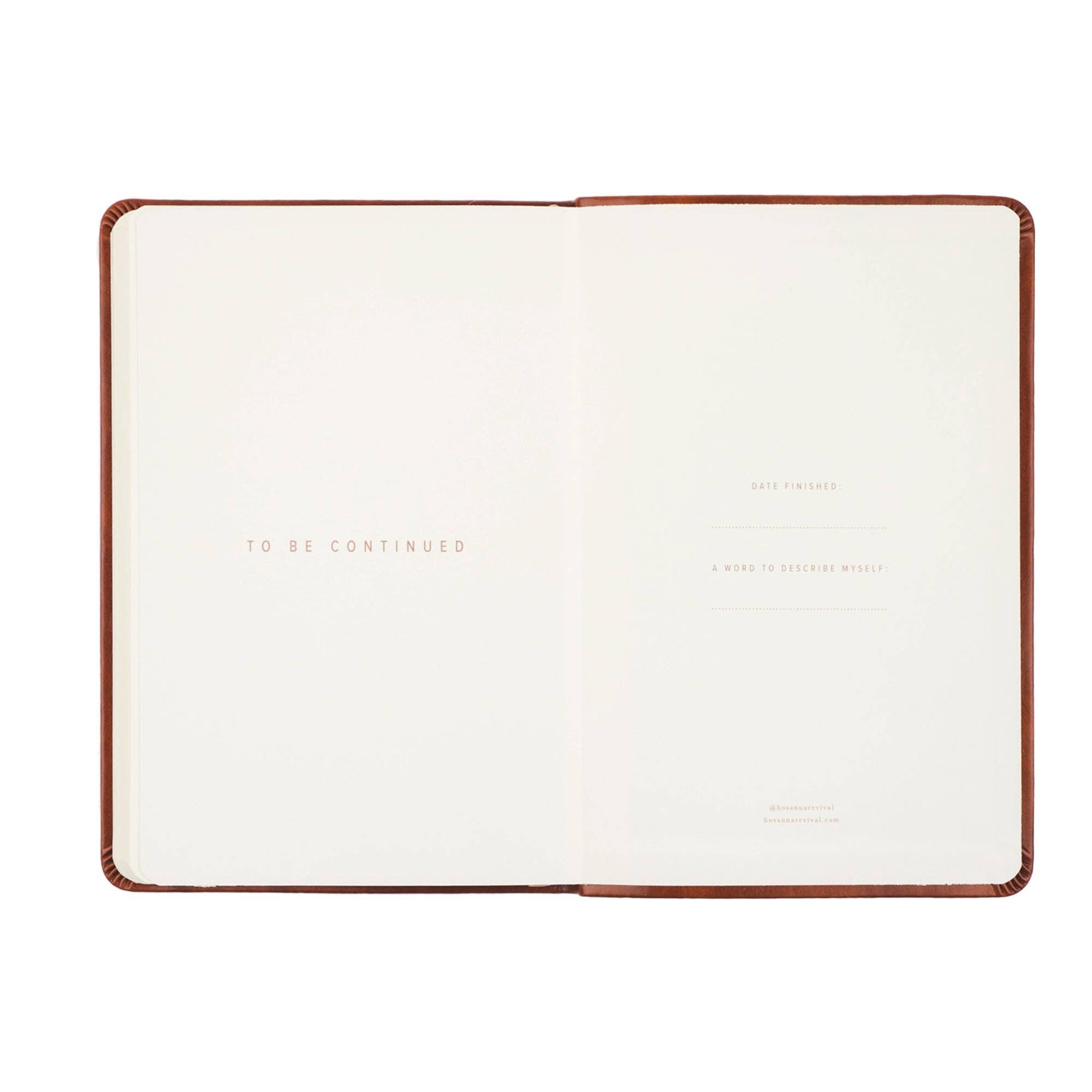 Open notebook with a brown leather cover on a white background