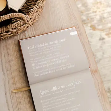 Open book with text on a wooden surface