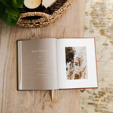 Open book with a photo of a castle on a wooden surface
