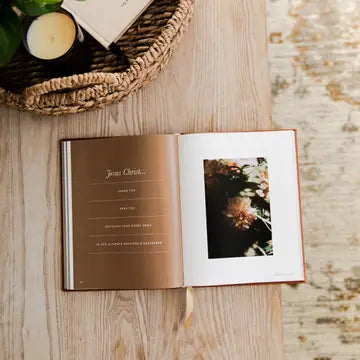 Open book with a photo on a wooden surface