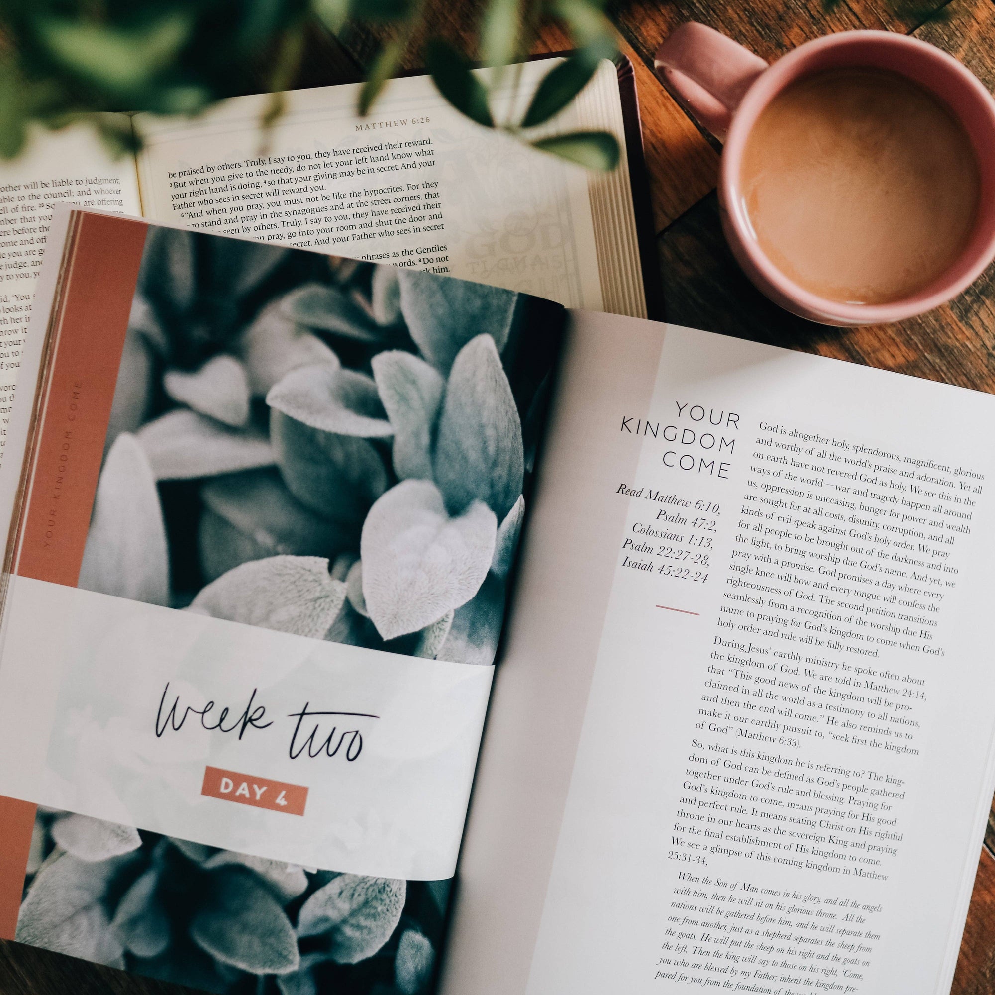 Open book with a coffee cup on a wooden surface