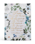 Notebook with floral design and text on a white background
