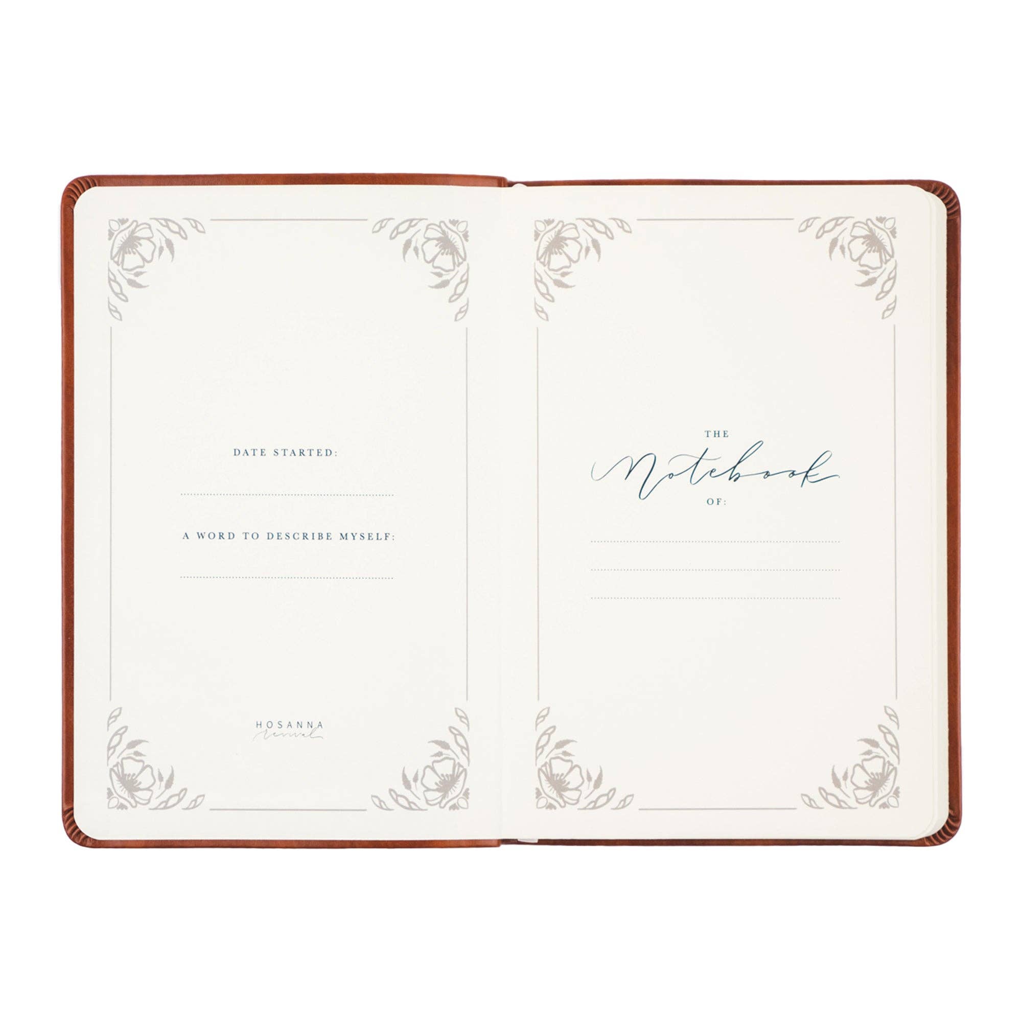 Open notebook with decorative cover and white pages on a white background