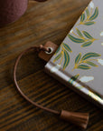 Notebook with a floral design on a wooden surface